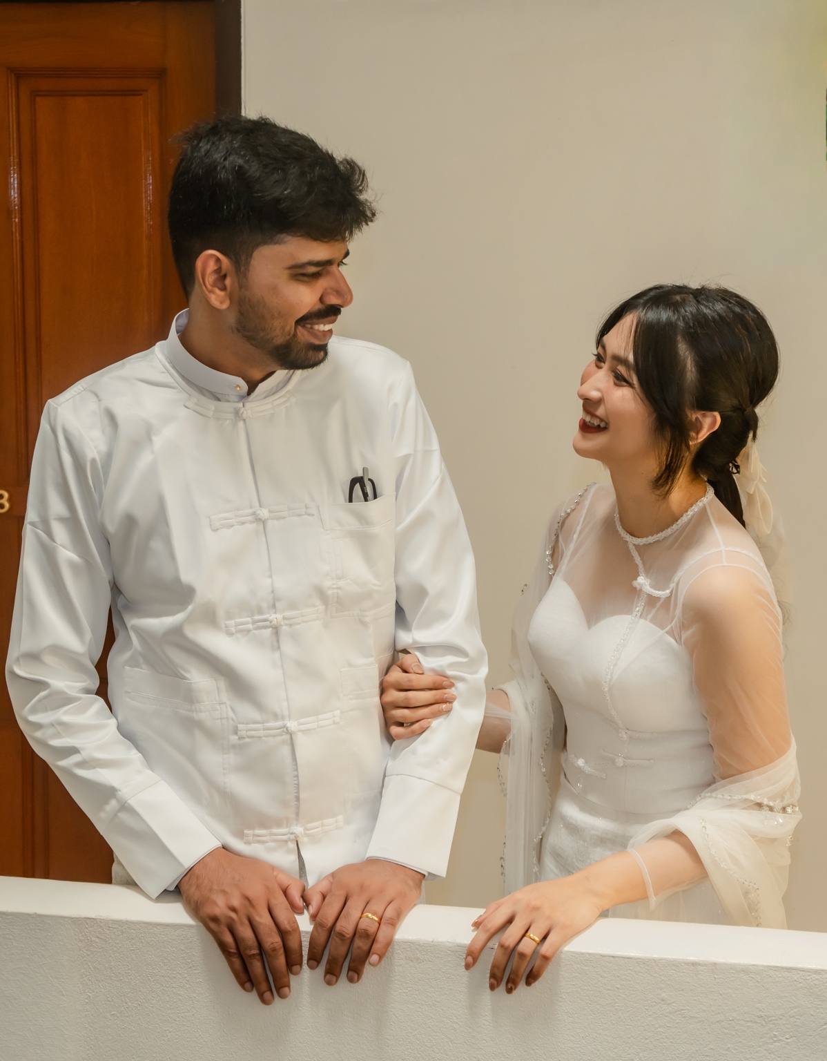 Vijay and Yati smiling together in white outfits